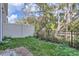 Fenced backyard with grass and tall trees visible over the fence at 1213 S Station Pl # 404, Orlando, FL 32809