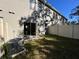 View of the home's exterior with sliding door and fenced yard at 1213 S Station Pl # 404, Orlando, FL 32827