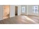 Bright bedroom with ample natural light and modern flooring near bathroom at 1213 S Station Pl # 404, Orlando, FL 32809