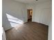 Neutral bedroom featuring wood-look floors, white walls and ample sunlight at 1213 S Station Pl # 404, Orlando, FL 32827