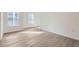 Bedroom with two windows providing ample natural light and modern flooring at 1213 S Station Pl # 404, Orlando, FL 32809