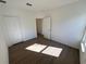 Neutral bedroom featuring wood-look floors, white walls and ample sunlight at 1213 S Station Pl # 404, Orlando, FL 32827