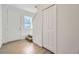 Bright entryway featuring wood floors, staircase, closet, and a white front door at 1213 S Station Pl # 404, Orlando, FL 32809