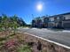 A street view of modern townhomes shows the landscaped lawns with trees and blue sky at 1213 S Station Pl # 404, Orlando, FL 32827