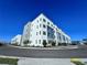 A low angle shows a white and gray modern apartment building at 1213 S Station Pl # 404, Orlando, FL 32827