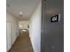 A well-lit hallway showcases wood-look flooring and leads to an open living space at 1213 S Station Pl # 404, Orlando, FL 32827