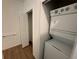 Bright laundry area with stacked washer and dryer and closet space at 1213 S Station Pl # 404, Orlando, FL 32827