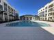 A community swimming pool with a clubhouse between two modern apartment buildings at 1213 S Station Pl # 404, Orlando, FL 32827