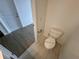 A clean and modern toilet within the bathroom, with light wood look tile at 1213 S Station Pl # 404, Orlando, FL 32827