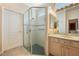 Bathroom featuring a glass-enclosed shower, neutral walls, and vanity sink at 126 Seville Chase Dr, Winter Springs, FL 32708