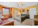 Bedroom with carpet, a ceiling fan, queen bed, closet and a window with decorative curtains at 126 Seville Chase Dr, Winter Springs, FL 32708