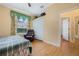 Bedroom with wood floors, a ceiling fan, closet and a window with decorative curtains at 126 Seville Chase Dr, Winter Springs, FL 32708