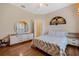 Bedroom with wood floors, a ceiling fan, dresser and a window with decorative curtains at 126 Seville Chase Dr, Winter Springs, FL 32708