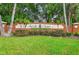 Seville Chase entrance sign with lush landscaping, brickwork, and palm trees provides a welcoming community atmosphere at 126 Seville Chase Dr, Winter Springs, FL 32708