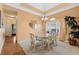 Charming dining room with a glass table, floral chairs, and window with soft lighting at 126 Seville Chase Dr, Winter Springs, FL 32708