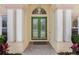 Close-up of the elegant front door, featuring decorative glass inserts and white columns at 126 Seville Chase Dr, Winter Springs, FL 32708