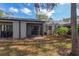 Exterior home view featuring a screened in back patio and mature trees at 133 Springwood Cir # A, Longwood, FL 32750