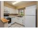 Efficient white kitchen with modern appliances and window view at 133 Springwood Cir # A, Longwood, FL 32750