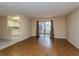 Open living room with sliding doors to screened porch and view into kitchen at 133 Springwood Cir # A, Longwood, FL 32750