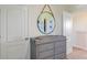 Cozy bedroom featuring dresser and a round mirror that reflects nautical decorations at 1336 Hanoverian Dr, Lake Alfred, FL 33850