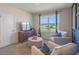 Relaxing living room with a large window, comfortable chairs, and a modern media center at 1336 Hanoverian Dr, Lake Alfred, FL 33850