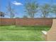 Spacious backyard with green grass enclosed by a brick privacy wall and seating at 1347 Benevolent St, Maitland, FL 32751