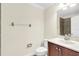 Well-lit bathroom with a tiled shower, wood vanity and a white sink at 1347 Benevolent St, Maitland, FL 32751