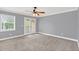 Cozy bedroom with carpet flooring, a ceiling fan, and natural light from the large window and glass paneled door at 1347 Benevolent St, Maitland, FL 32751