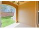 Covered patio with an arched entrance, overlooking a lush green lawn and brick privacy wall at 1347 Benevolent St, Maitland, FL 32751