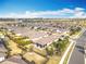 An aerial view of a property with a well-manicured lawn and cozy patio, nestled in a peaceful residential community at 1374 Zeek Ridge St, Clermont, FL 34715