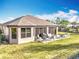 Charming backyard with a patio, outdoor seating, and plenty of green space for relaxation and recreation at 1374 Zeek Ridge St, Clermont, FL 34715