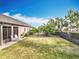 Spacious backyard featuring a well-maintained lawn and a black fence that adds privacy and security to the property at 1374 Zeek Ridge St, Clermont, FL 34715