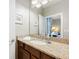 Bathroom vanity with granite countertops, large mirror, and view into the bedroom at 1374 Zeek Ridge St, Clermont, FL 34715