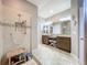 Bathroom featuring a tiled walk-in shower, a double vanity, and a dressing table at 1374 Zeek Ridge St, Clermont, FL 34715