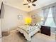 Bedroom featuring a ceiling fan, carpeted floors, a window with curtains, side tables with lamps, and artwork at 1374 Zeek Ridge St, Clermont, FL 34715