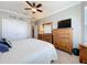 Bedroom featuring light gray walls, ceiling fan, a double door closet, wood dresser, and carpeted floors at 1374 Zeek Ridge St, Clermont, FL 34715