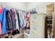 A closet with wire shelving, hanging clothes and filing cabinet at 1374 Zeek Ridge St, Clermont, FL 34715