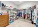 A closet with wire shelving, hanging clothes, and a dresser at 1374 Zeek Ridge St, Clermont, FL 34715