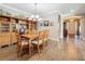 Cozy dining area features a wooden table with seating and built-in display shelving with access to front entry at 1374 Zeek Ridge St, Clermont, FL 34715