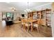 Open-concept dining area features a wooden table set, built-in display shelving and seamless access to the living room at 1374 Zeek Ridge St, Clermont, FL 34715