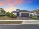 Beautiful single Gathering home with a manicured lawn, paver driveway, and two car garage at 1374 Zeek Ridge St, Clermont, FL 34715