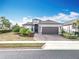 Beautiful single Gathering home with a manicured lawn, paver driveway, and two car garage at 1374 Zeek Ridge St, Clermont, FL 34715