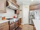 Well-equipped kitchen with stainless steel range hood, stainless fridge, and custom cabinetry at 1374 Zeek Ridge St, Clermont, FL 34715