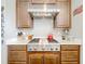 Close-up of the well-appointed kitchen, featuring stainless steel appliances and modern range hood at 1374 Zeek Ridge St, Clermont, FL 34715