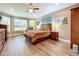 Spacious main bedroom featuring wood flooring, a ceiling fan, and a large window seat at 1374 Zeek Ridge St, Clermont, FL 34715