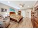 Spacious main bedroom featuring wood flooring, a seating area, and ensuite access at 1374 Zeek Ridge St, Clermont, FL 34715