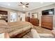 Spacious main bedroom featuring wood flooring, a ceiling fan, and ensuite access at 1374 Zeek Ridge St, Clermont, FL 34715