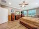 Spacious main bedroom featuring wood flooring, large windows, and plenty of dresser storage at 1374 Zeek Ridge St, Clermont, FL 34715