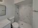 Bathroom featuring a vanity, toilet, and a walk-in shower with marble tiling at 145 Zacalo Way, Kissimmee, FL 34743