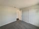 Bedroom featuring neutral walls, gray carpet, and a closet at 145 Zacalo Way, Kissimmee, FL 34743